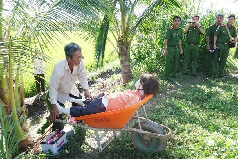 Tuyền sợ hãi, kéo nạn nhân ra bờ ao cách hiện trường 50m rồi đem bình điện cùng xuyệt cá về nhà cất giấu.- Thực nghiệm hiện trường. Ảnh: Báo Dân trí.