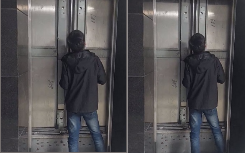 Bảo vệ tại chung cư HH03C TDP4 cạy cửa thang máy để giải cứu người dân bị mắc kẹt. Ảnh: Lao Động