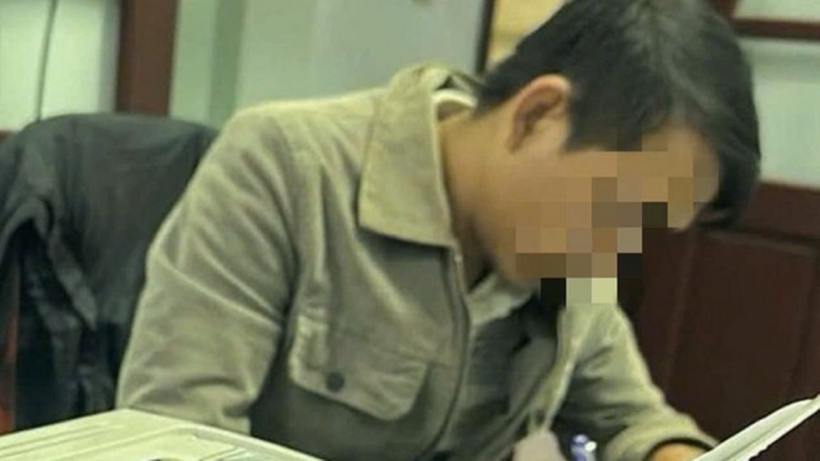 Đối tượng N.V.T. làm việc với cơ quan công an. Ảnh: Tiền Phong