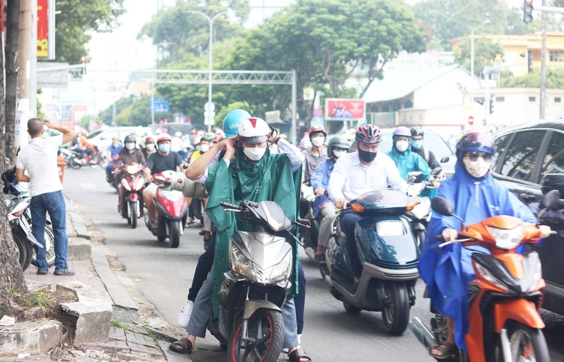 Việc dừng xe mặc áo mưa tưởng chừng như một hành động đơn giản nhưng lại tiềm ẩn nguy cơ vi phạm luật giao thông nếu không được thực hiện đúng cách. Ảnh minh họa