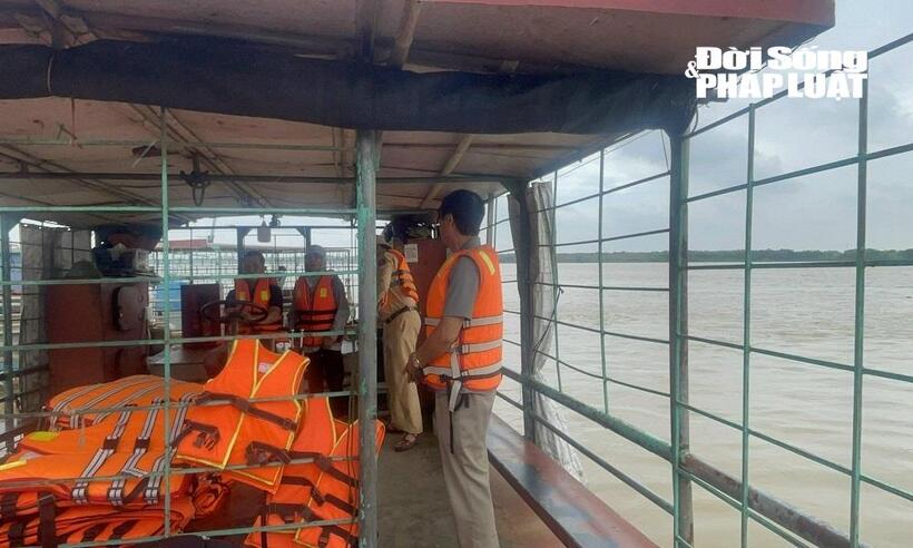 Lực lượng CSGT đang kiểm tra nhắc nhở lái tàu và hành khách phà chở khách ở bến đò Liên Trung, TP Hà Nội.