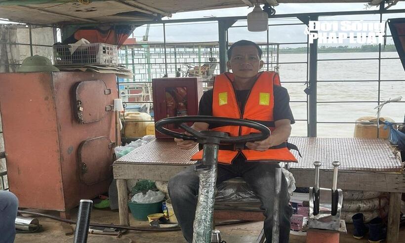 Anh Hoàng Văn Giang, người lái tàu tại bến đò Liên Trung.