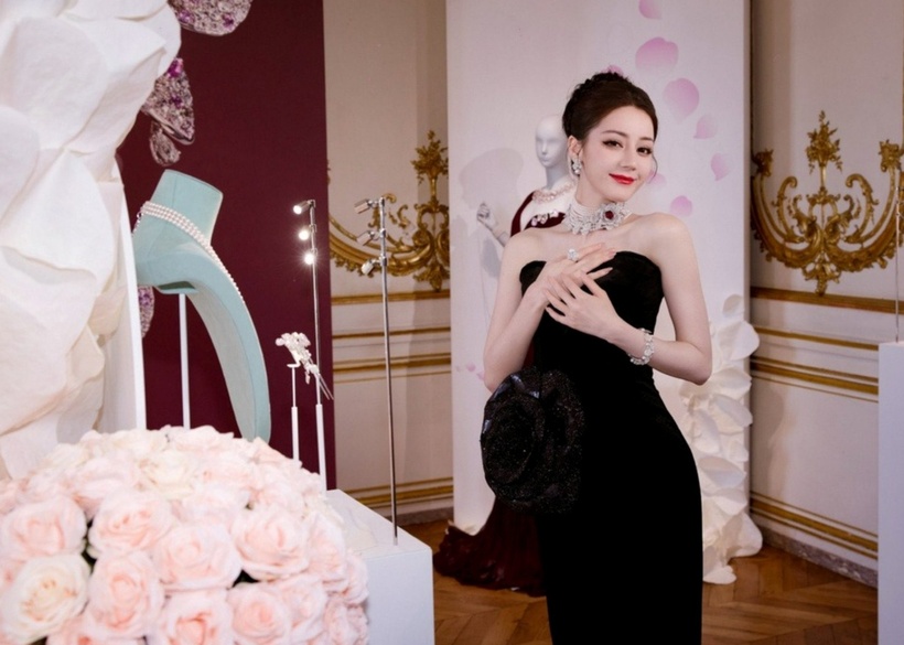 Xuất hiện lộng lẫy và sang chảnh, Địch Lệ Nhiệt Ba gây ấn tượng với thần thái và vóc dáng đỉnh cao trong bộ đầm đen ôm sát, với thiết kế cúp ngực gợi cảm tôn lên bờ vai trần mảnh mai. Phom váy dáng dài được cắt may tinh tế, ôm sát phần eo và hông, kết hợp với chi tiết hoa hồng đen làm nổi bật thân hình đồng hồ cát lý tưởng.