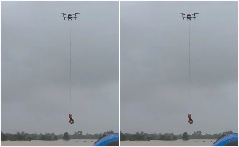 Lực lượng chức năng dùng máy bay không người lái cứu sống nạn nhân trong nước lũ. (Ảnh: Cơ quan công an)