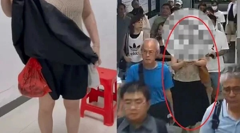 Dưới chiếc váy đen dài là hai túi nylon lớn được buộc bằng túi đỏ và trắng. Ảnh: Saostar.