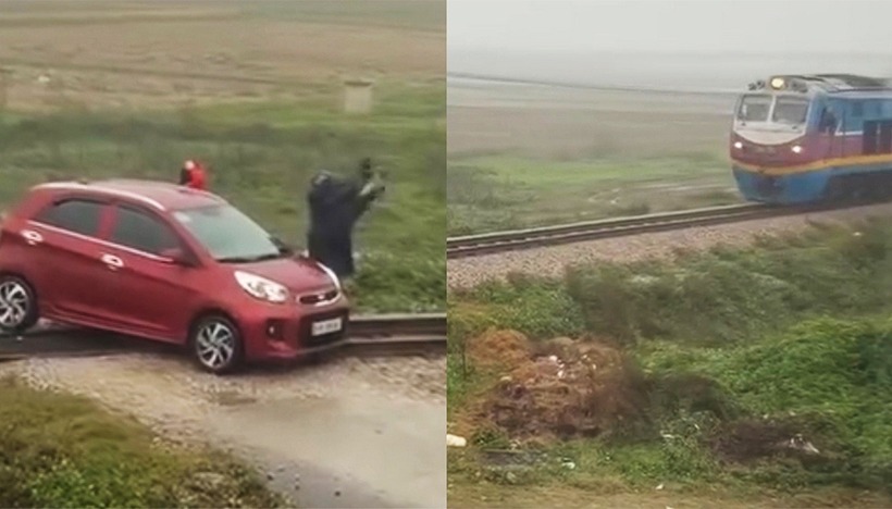 Người dân ra tín hiệu nguy hiểm, tàu hàng đã kịp dừng cách ô tô không xa, tránh xảy ra va chạm trên đường sắt (Ảnh cắt từ clip).