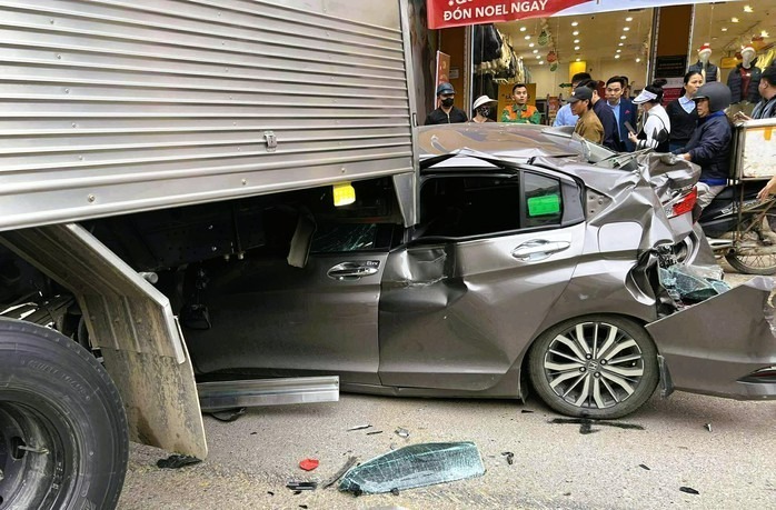 Chiếc ô tô con bẹp dúm phần đuôi, đầu và bên sườn. (Ảnh: Người lao động)