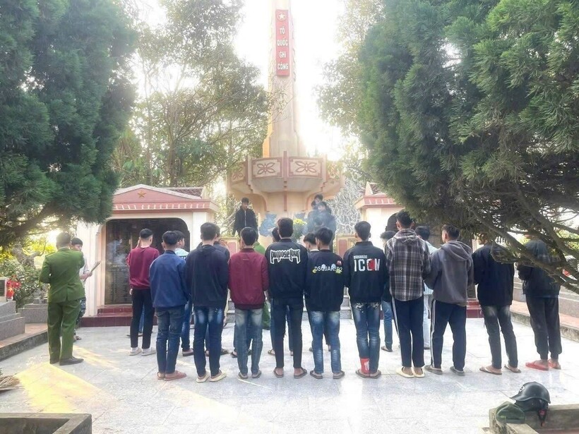 Các thanh thiếu niên tham gia dọn dẹp, vệ sinh khuôn viên nghĩa trang. Ảnh: Công an tỉnh Lào Cai.