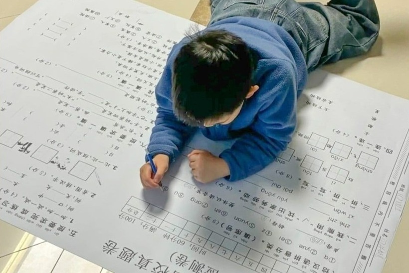 Một số bậc phụ huynh ở Trung Quốc đã in những tấm bài tập về nhà khổ lớn để khuyến khích con cái học. Ảnh: REDNOTE
