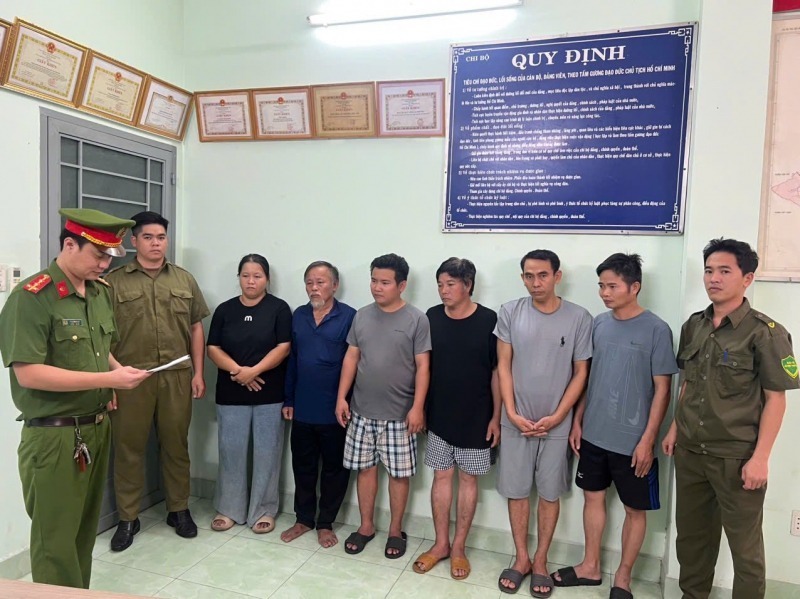 Cơ quan CSĐT tống đạt các quyết định tố tụng đối với các đối tượng trong đường dây sản xuất hàng giả. Ảnh: Công an nhân dân.