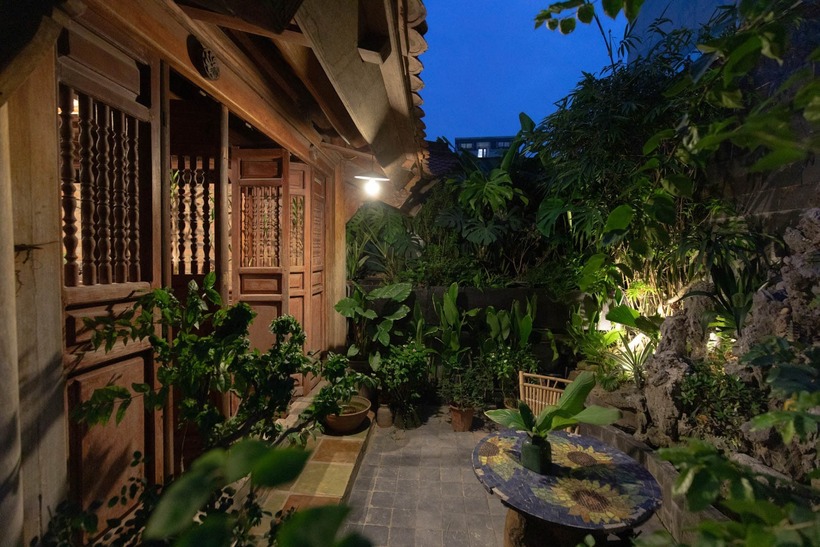 Tọa lạc tại khu vực An Trạch sầm uất, căn nhà phố của gia đình anh Vũ Huy gây bất ngờ bởi một khoảng lặng xanh mướt nằm tách biệt trên cao. Ít ai có thể hình dung được rằng, phía trên sự hối hả của dòng người xe lại là một không gian "nhà quê trong phố" đầy mộc mạc với mái ngói rêu phong và tiếng nước chảy róc rách.