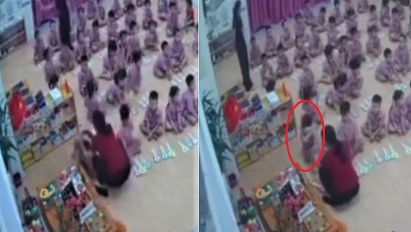 Cảnh bé trai nghi bị "tác động" và phản xạ bằng cách đưa 2 tay ôm đầu. Ảnh: Dân trí