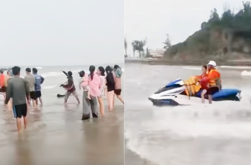 Lực lượng cứu hộ đưa hai em nhỏ vào bờ. (Ảnh: Tuổi trẻ)