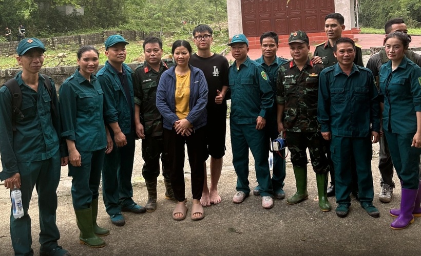 Nam sinh viên và mẹ chụp ảnh cùng đội cứu hộ. Ảnh: Báo Tin tức & Dân tộc