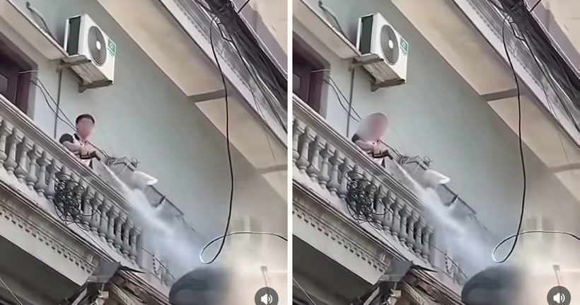 Hình ảnh người đàn ông liên tục xịt nước vào thợ tháo dỡ công trình gây bức xúc dư luận. (Ảnh: Cắt clip)