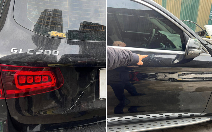 Chiếc xe Mercedes bị cào xước, bẻ gương, đập kính. Ảnh: Người Lao Động.