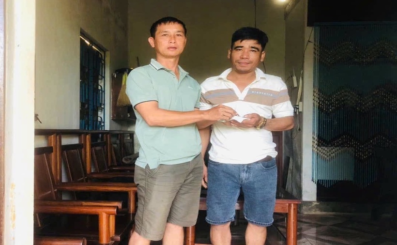 Anh Cường (bên phải) trao lại số vàng cho anh Thắng. (Ảnh: VietnamNet)