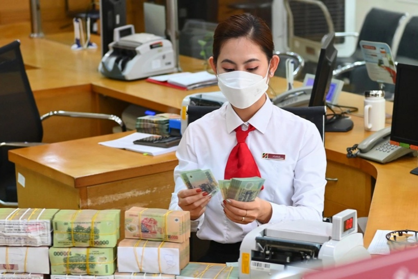 Nhân viên ngân hàng giao dịch tại quầy (Ảnh: Tiến Tuấn).