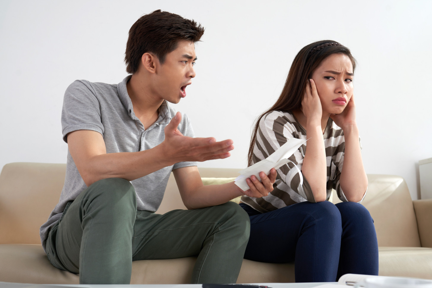 medium shot asian man shouting his wife holding piece paper