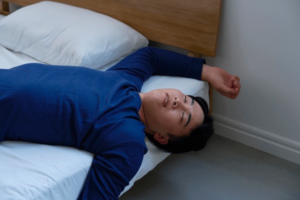 asian man sleeping bad posture 600nw 2721768335