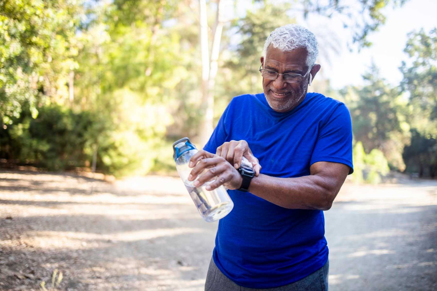 older man checking watch after workout what is brisk walking