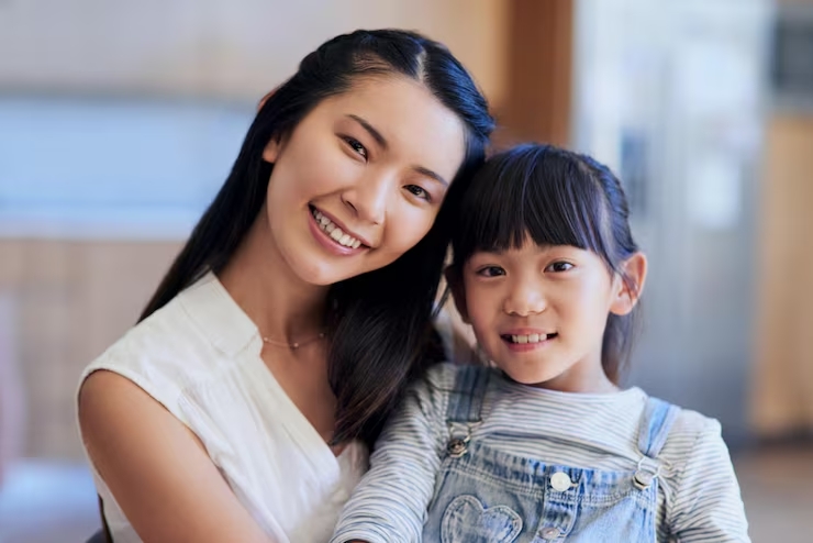 mother girl portrait home with hug bonding support relationship together as family asian mom daughte