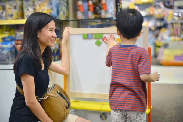 depositphotos182612760 stock photo young asian mother and her