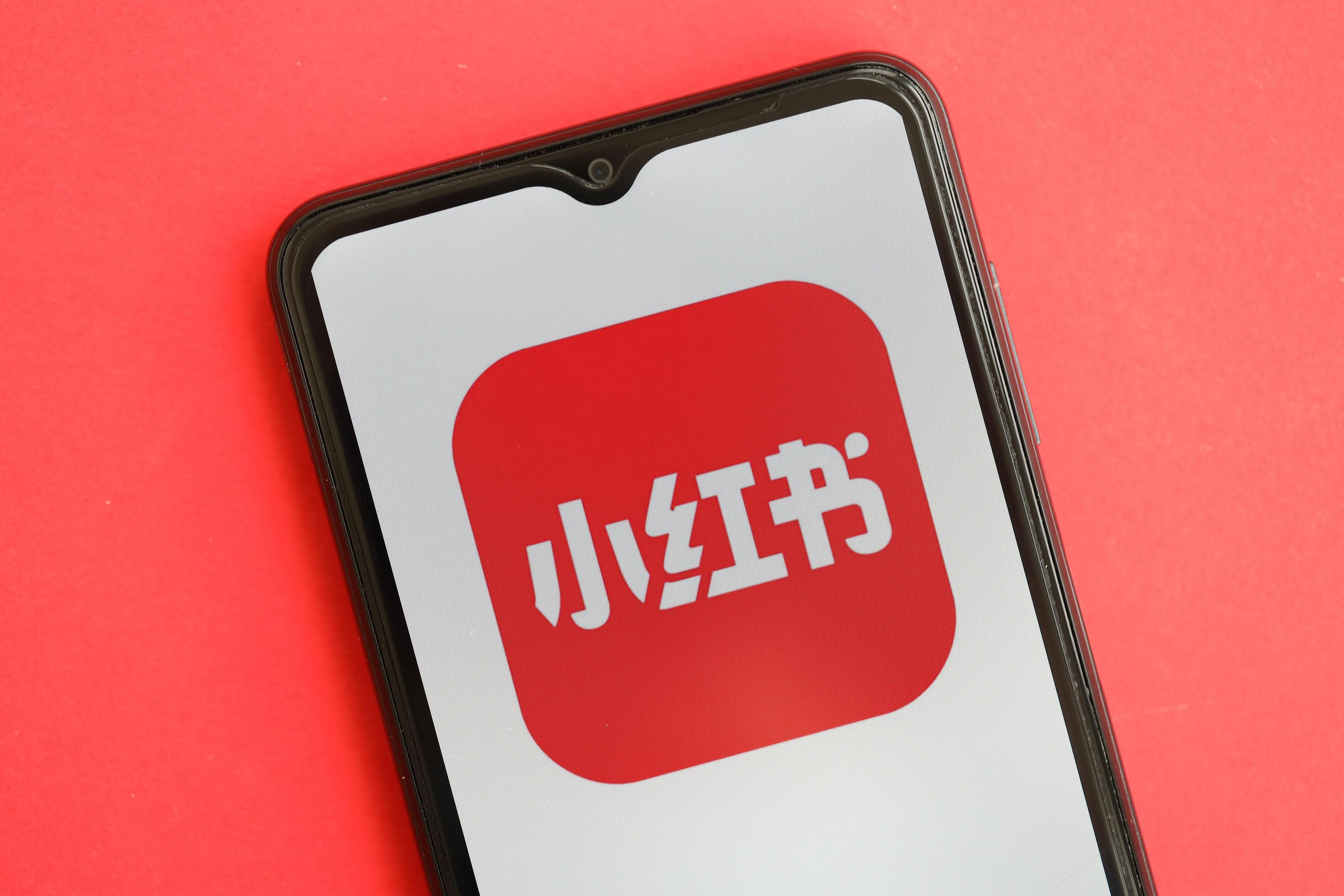 kyiv ukraine april 1 2024 xiaohongshu icon on smartphone screen on red table free photo