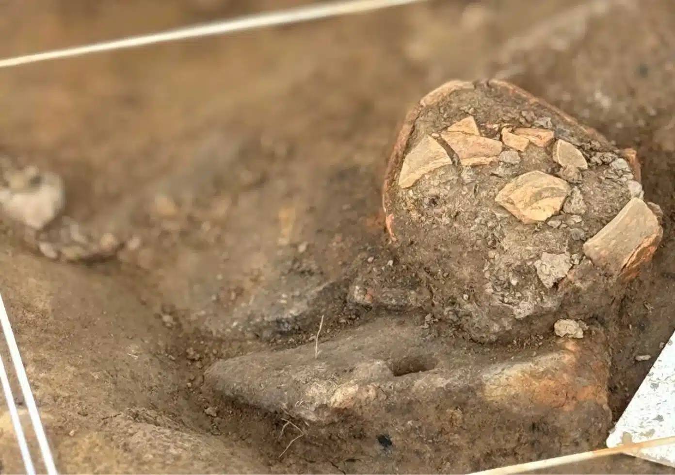 excavation of a sigillata ceramic cup in the northeast corner of the structure credit patrick ernaux inrap 1 1392x979jpg