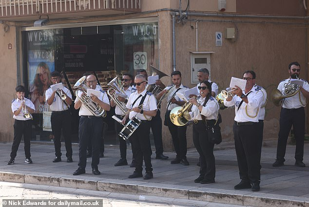 109175575 15880453 standingonthepavementtheybeganplayingtheirtrombonesand a 151780818606636