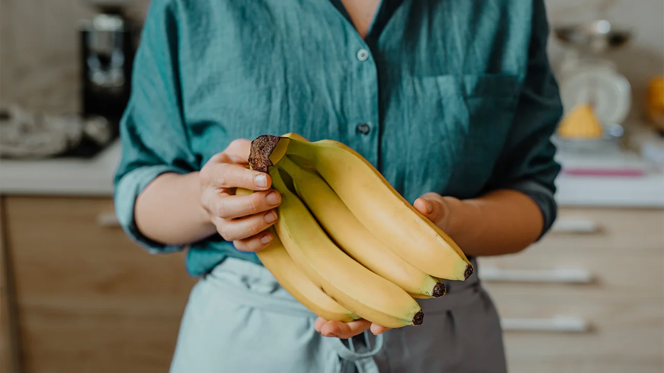 bananas holding health benefits 1296x728 header