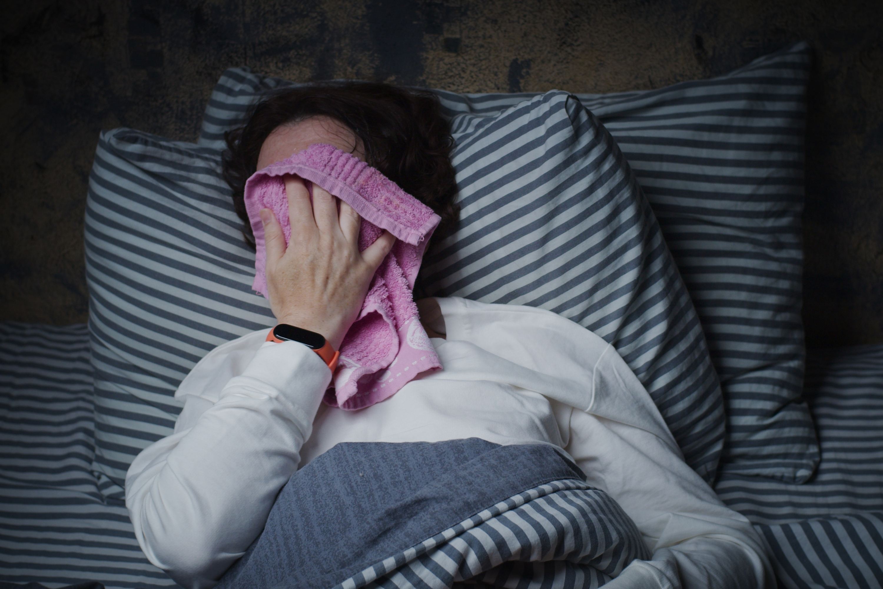 mature woman suffering from night sweats gettyimages 1324369881