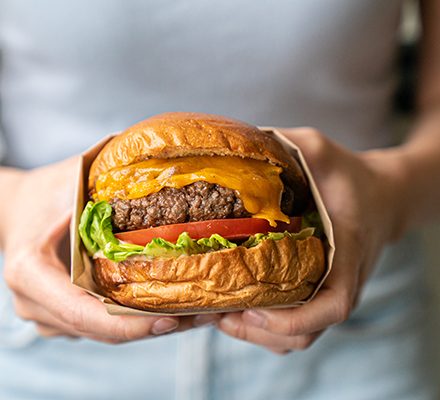 hands holding beef burger c3eee6d