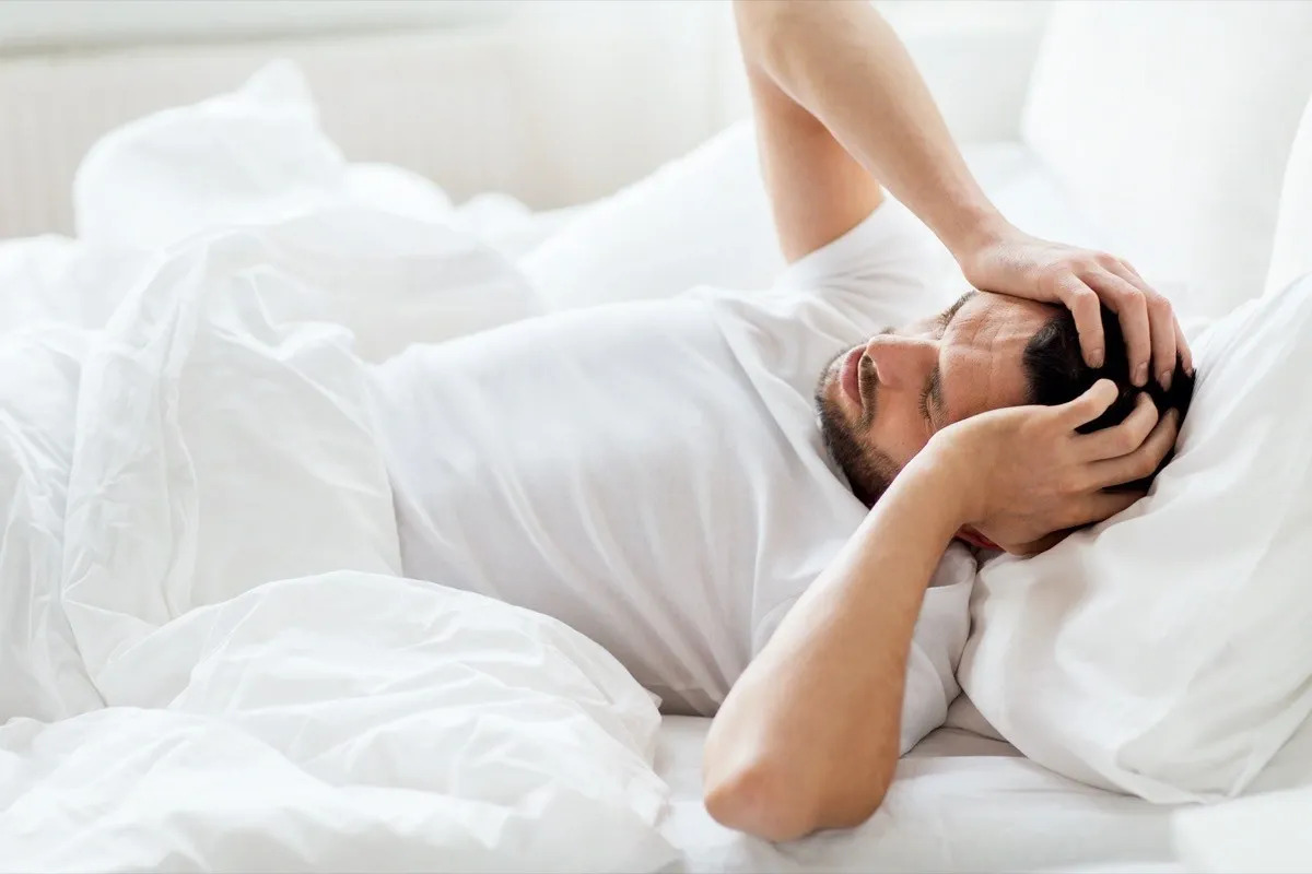 man bed headache hangover sleep 16990626975472107295508