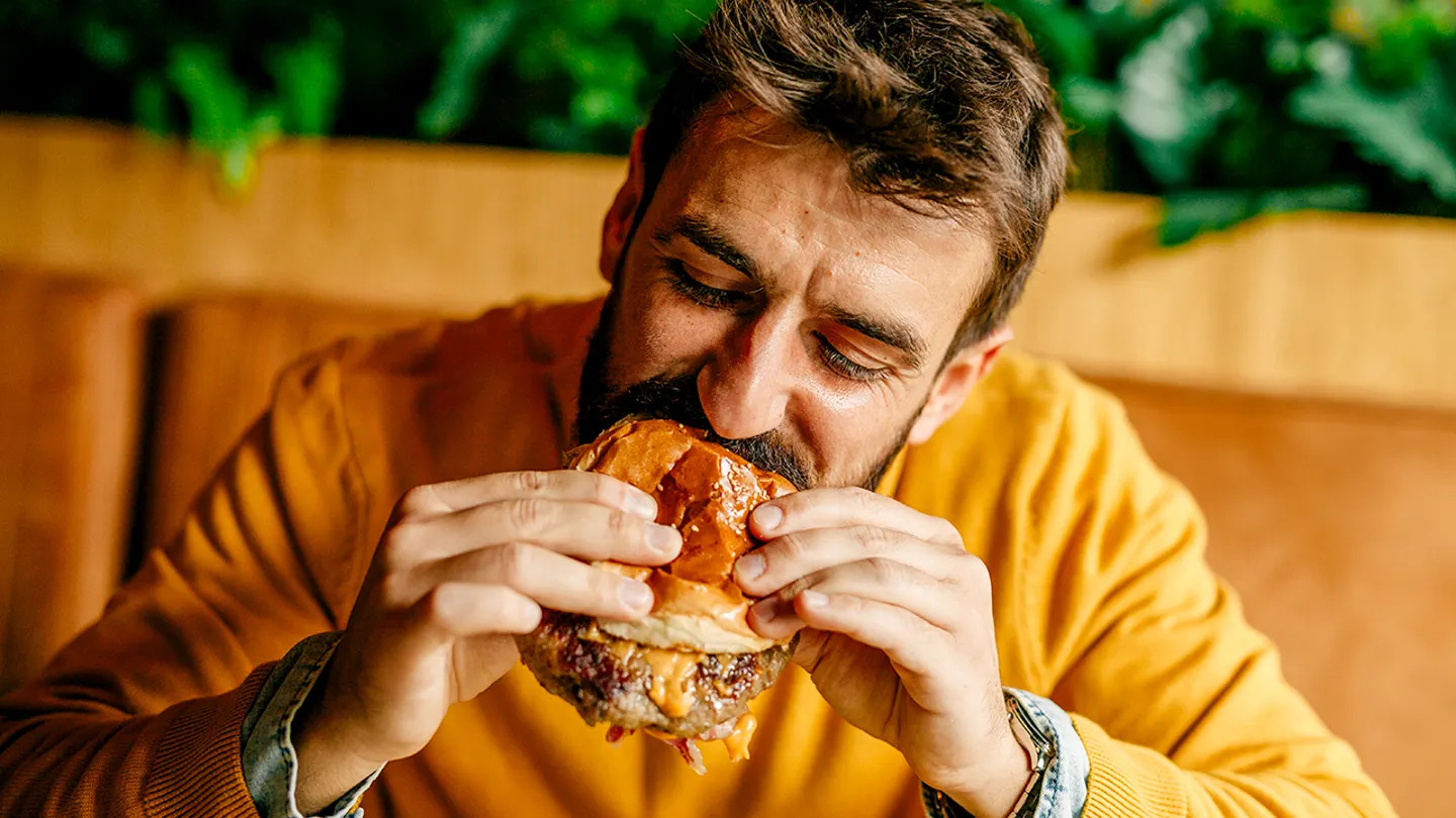 man eating hamburger