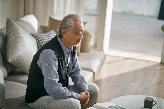 sad asian old man sitting alone couch home1138083 3594