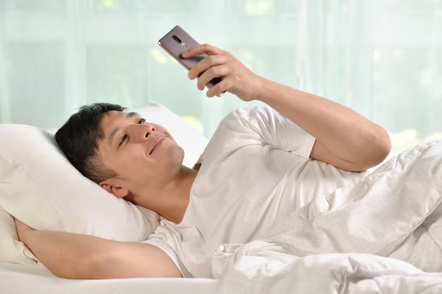 young asian man using smartphone bed after waking up morning126277 1381