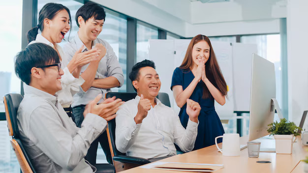 millennial group young businesspeople asia businessman businesswoman celebrate giving five after dealing feeling happy signing contract agreement meeting room small modern office7861 2498