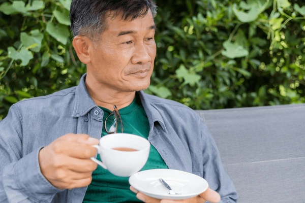 asian working man relaxing drinking 600nw 2202283131