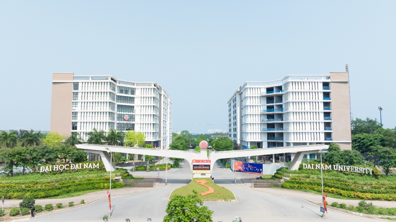 A bridge over a road with buildings in the background Description automatically generated