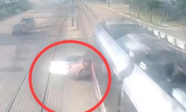 Clip: Cố tình vượt đèn đỏ, lao qua đường ray, ô tô bị tàu hỏa kéo lê, suýt bị xé đôi